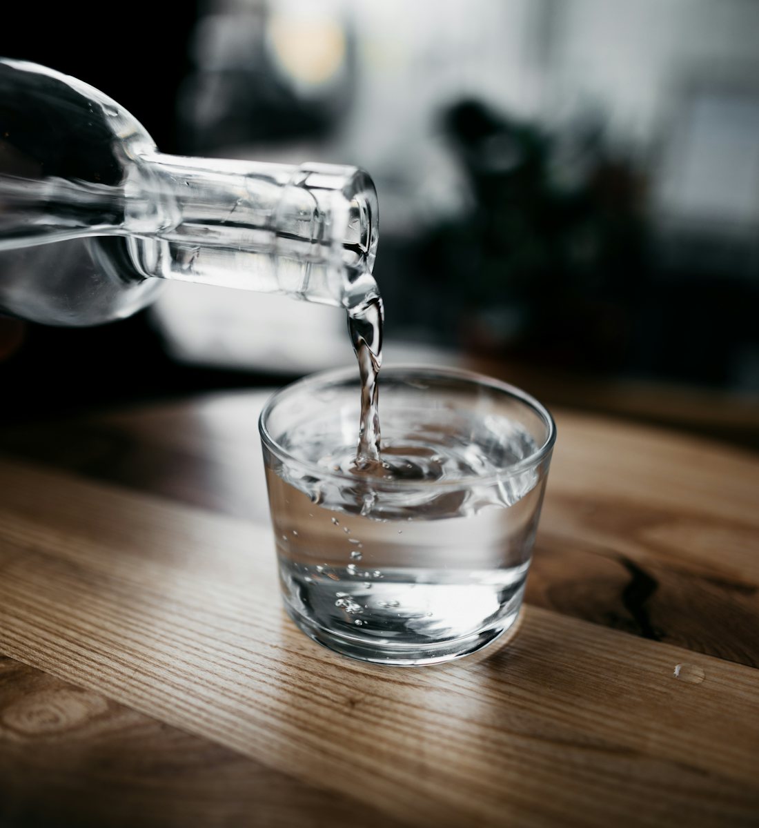 Clean, soft water being poured into a glass in a DFW home
